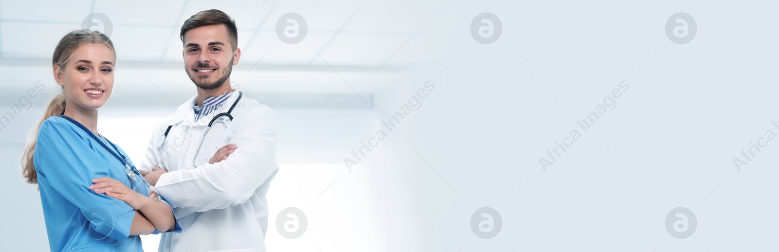 Image of Happy doctors in uniform at workplace, space for text. Banner design