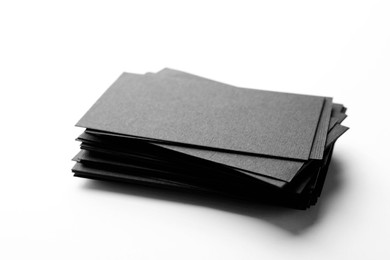 Photo of Blank black business cards on white background, closeup. Mockup for design