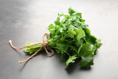 Bunch of fresh coriander on gray table