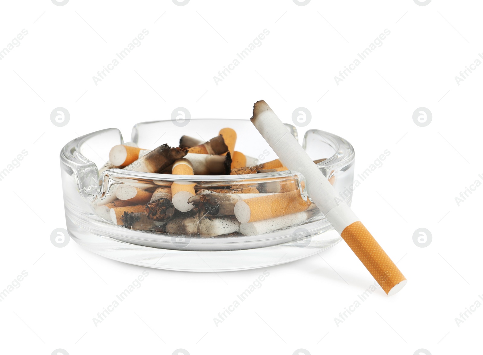 Photo of Glass ashtray with cigarette stubs isolated on white