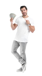 Handsome young man with dollars on white background