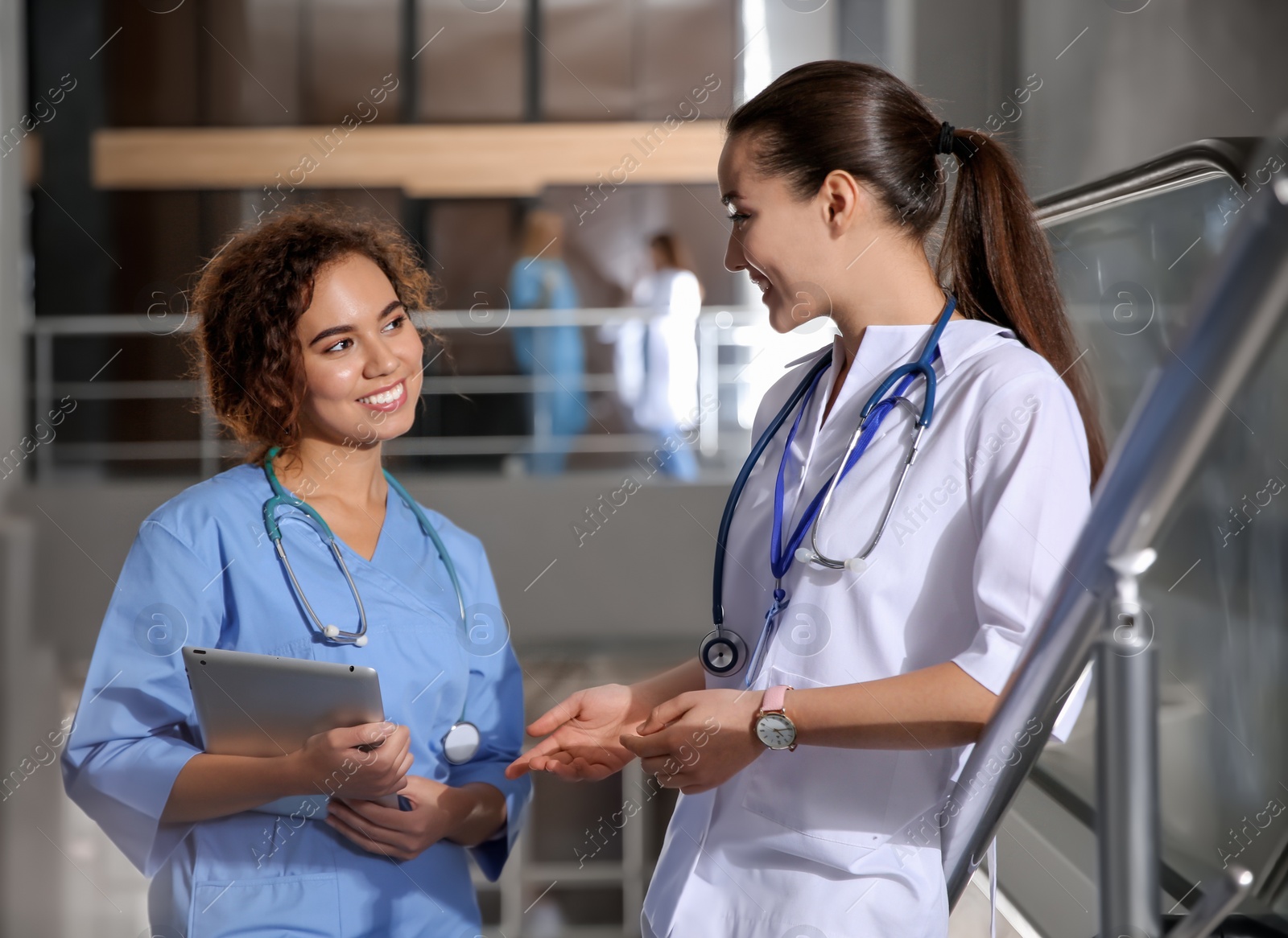 Photo of Happy medical students in modern college hallway