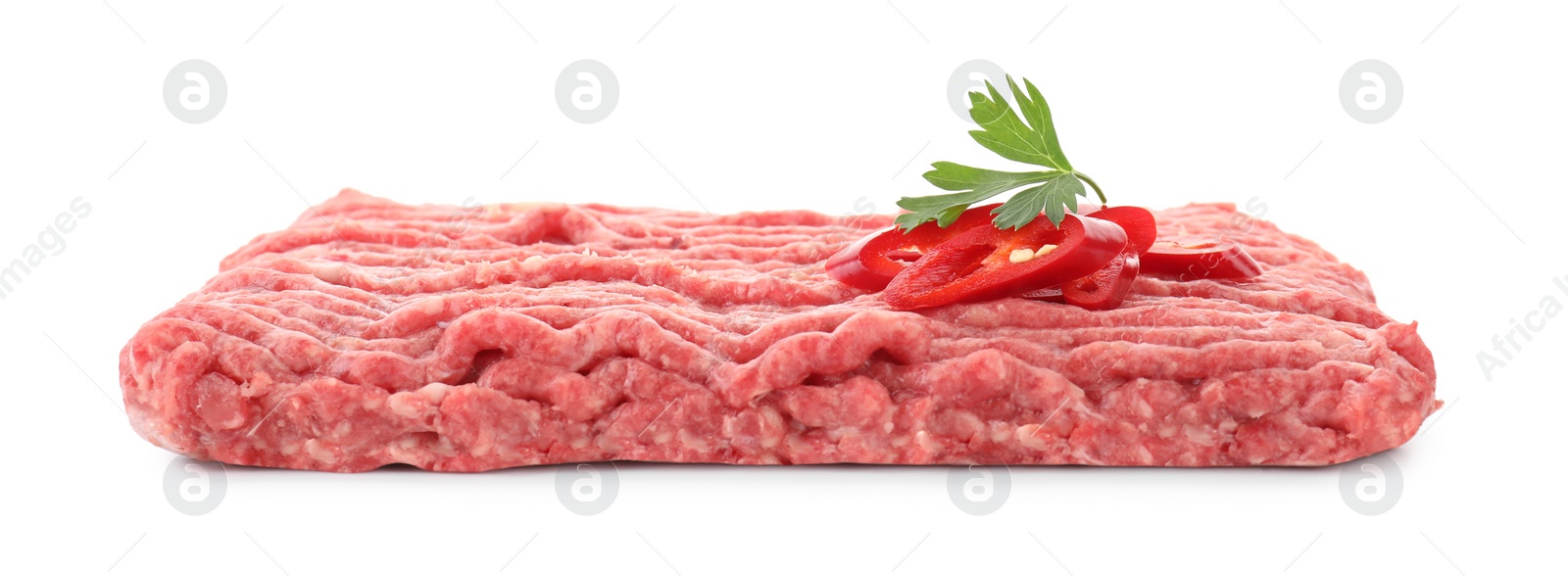 Photo of Raw ground meat, chili pepper and parsley isolated on white