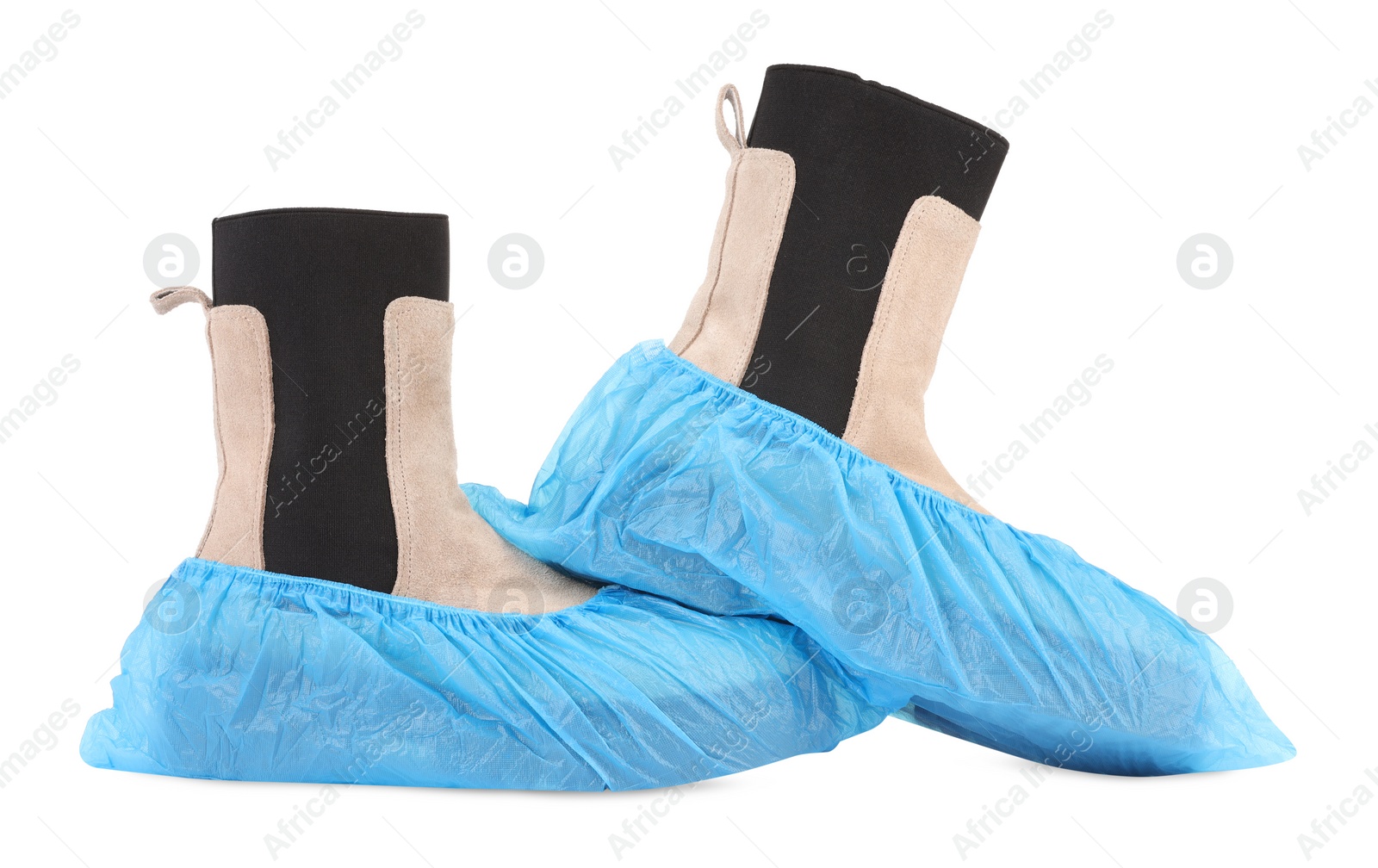 Photo of Women's boots in blue shoe covers isolated on white