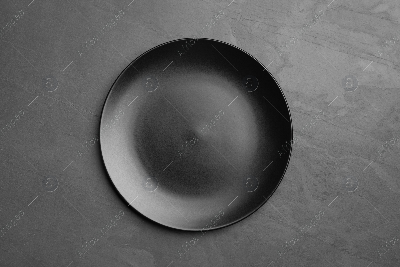 Photo of Stylish ceramic plate on dark background, top view