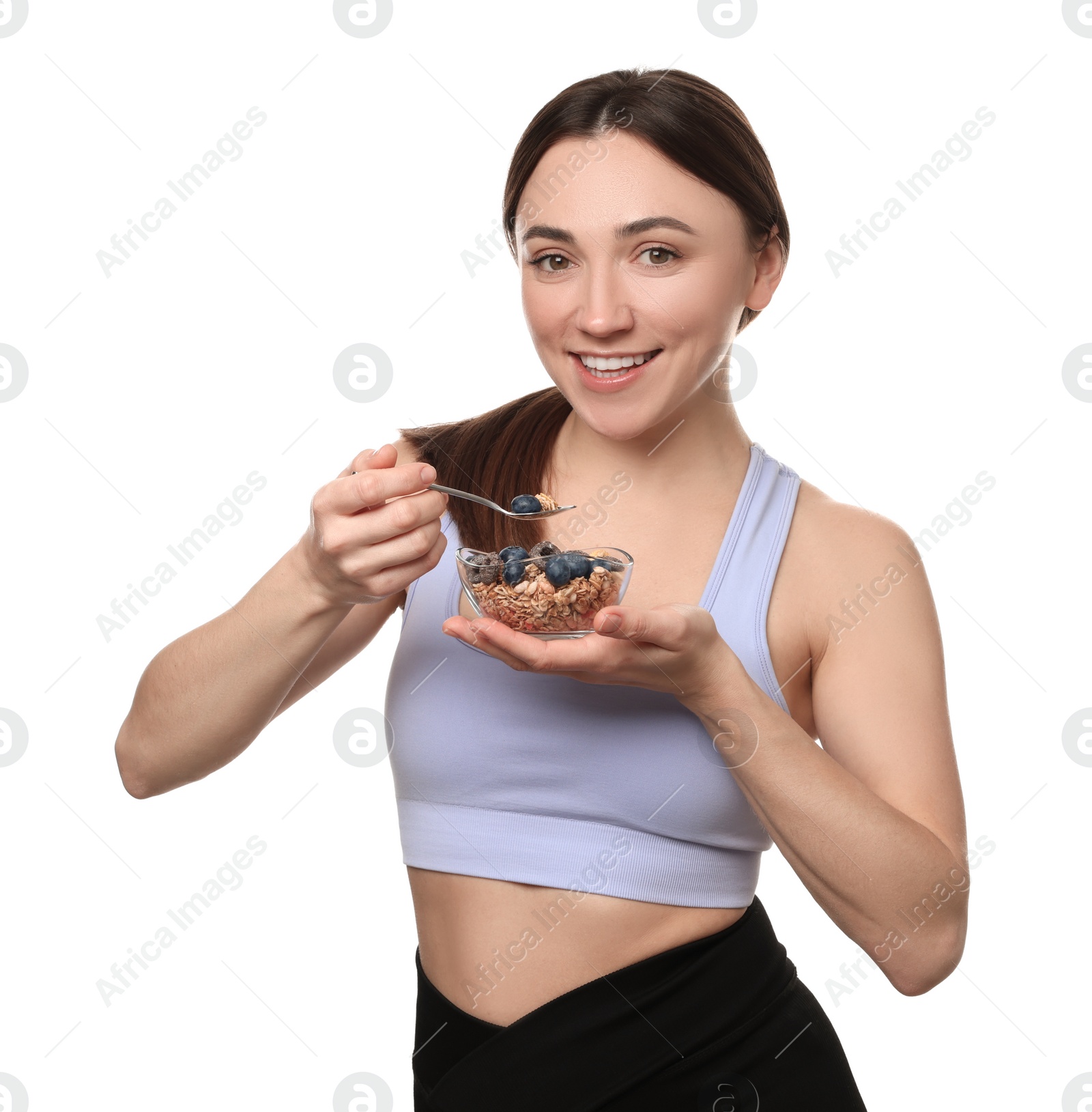 Photo of Happy woman eating tasty granola with fresh berries on white background