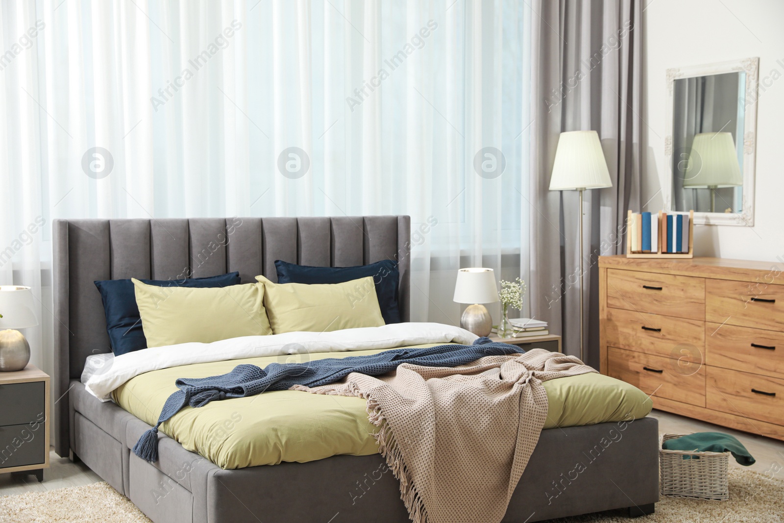 Photo of Stylish bedroom interior with large comfortable bed