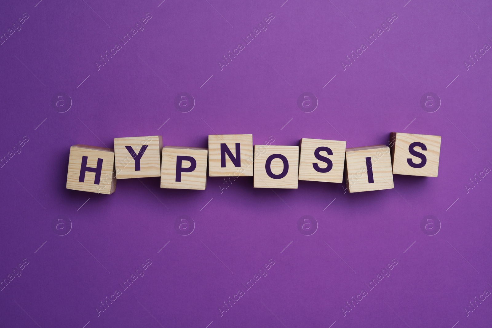 Photo of Wooden blocks with word HYPNOSIS on purple background, flat lay