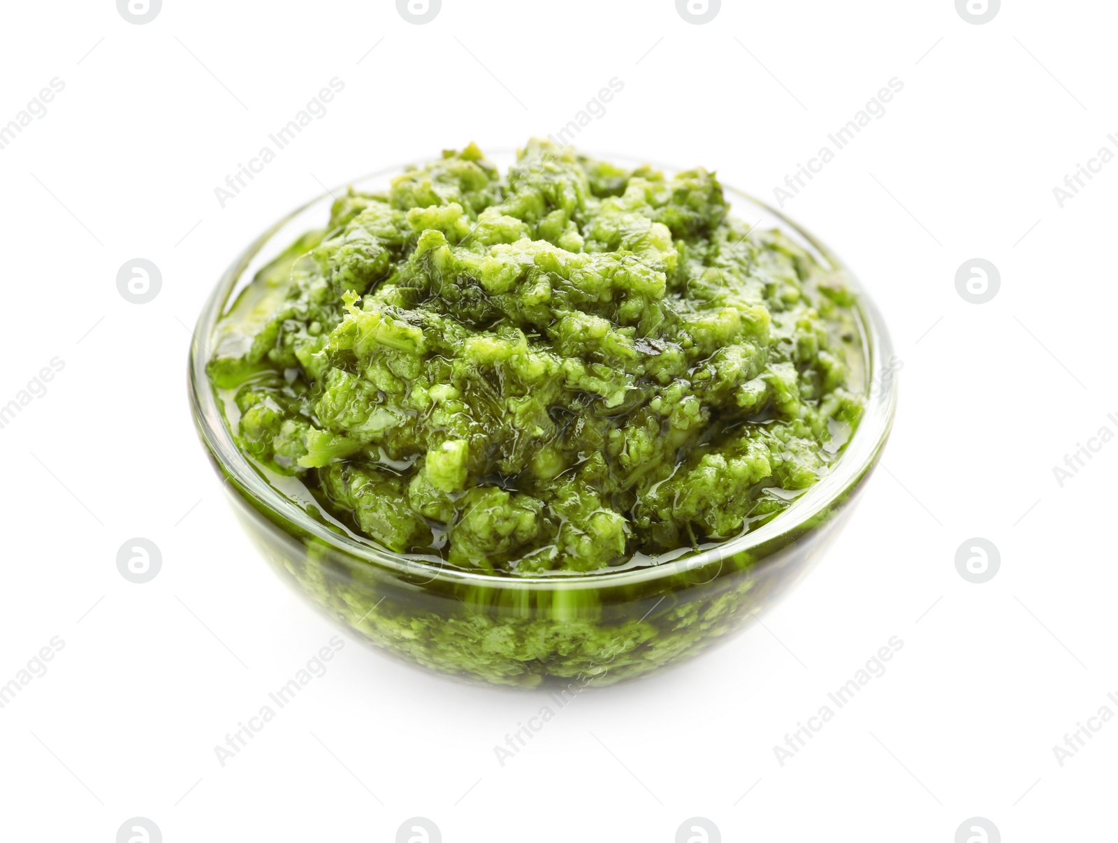 Photo of Bowl of tasty pesto sauce isolated on white