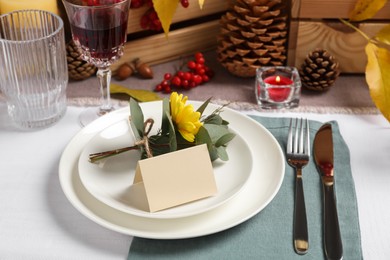 Photo of Beautiful autumn place setting with blank card and decor on table