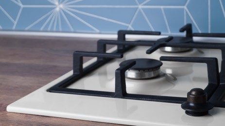 Photo of Modern gas cooktop in kitchen, closeup. Space for text