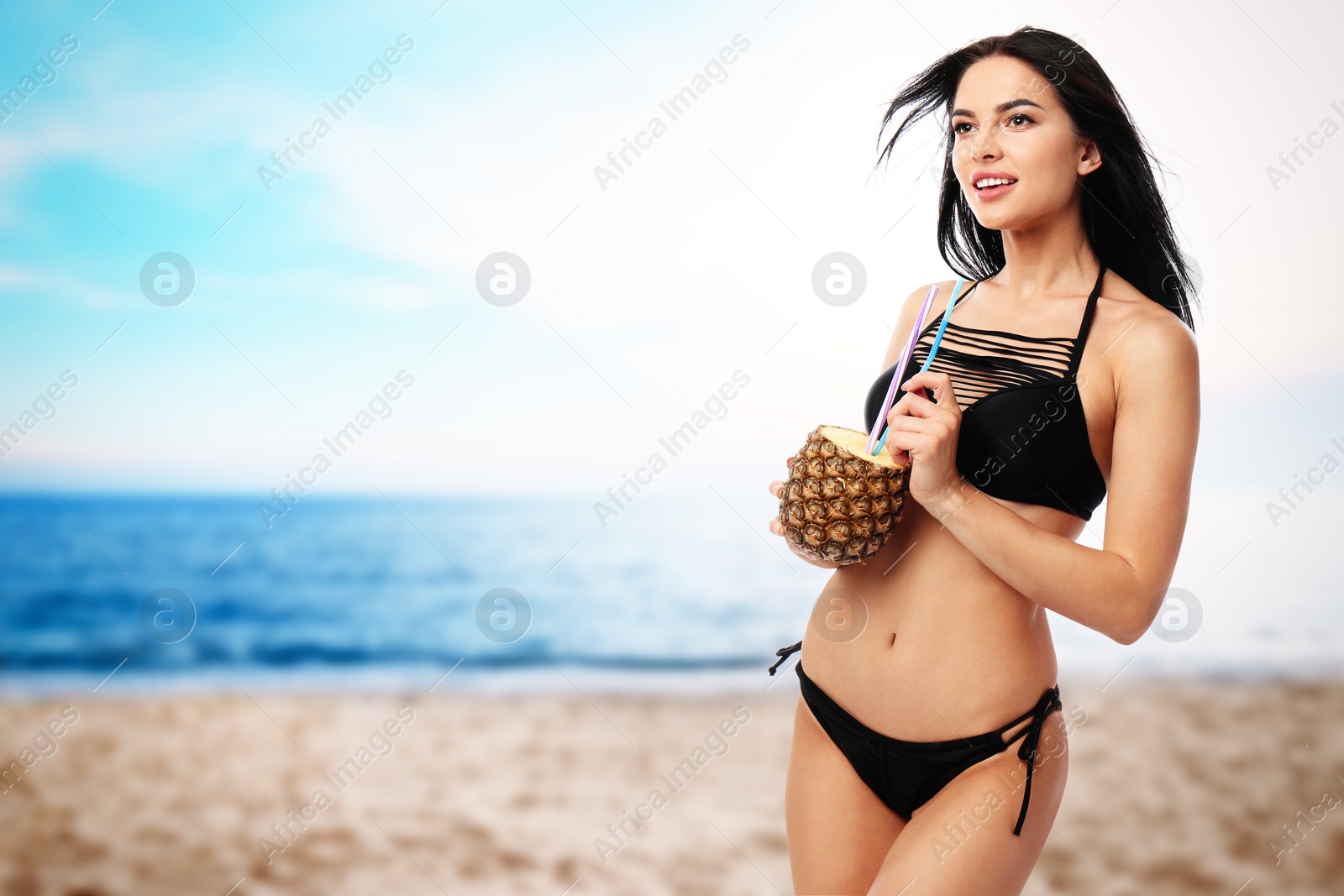 Image of Beautiful young woman in black bikini with cocktail at beach on sunny day, space for text