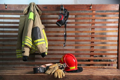 Firefighter`s uniform, helmet, gloves and mask at station