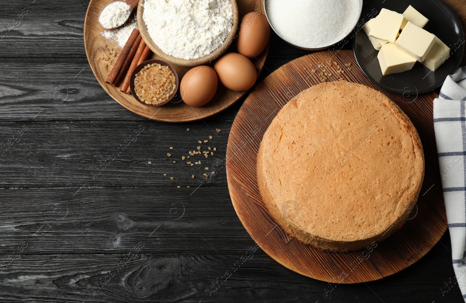 Photo of Flat lay composition with delicious fresh homemade cake on black wooden table