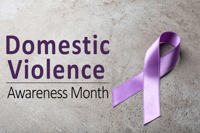 Image of Purple ribbon on grey background. Symbol of Domestic Violence Awareness