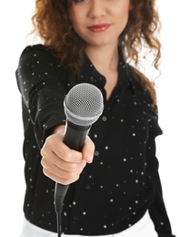 Curly African-American woman holding microphone on white background. Space for text