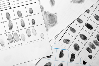 Police forms with fingerprints, top view. Forensic examination
