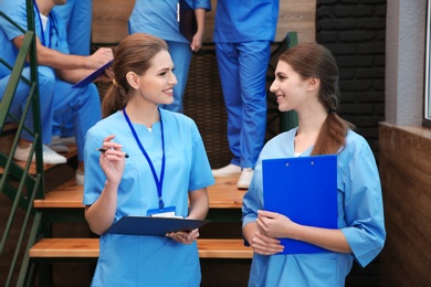 Young smiling medical students in university hall
