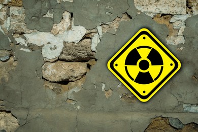 Image of Radioactive sign on old cracked wall. Hazard symbol