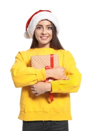 Young woman with Christmas gift on white background