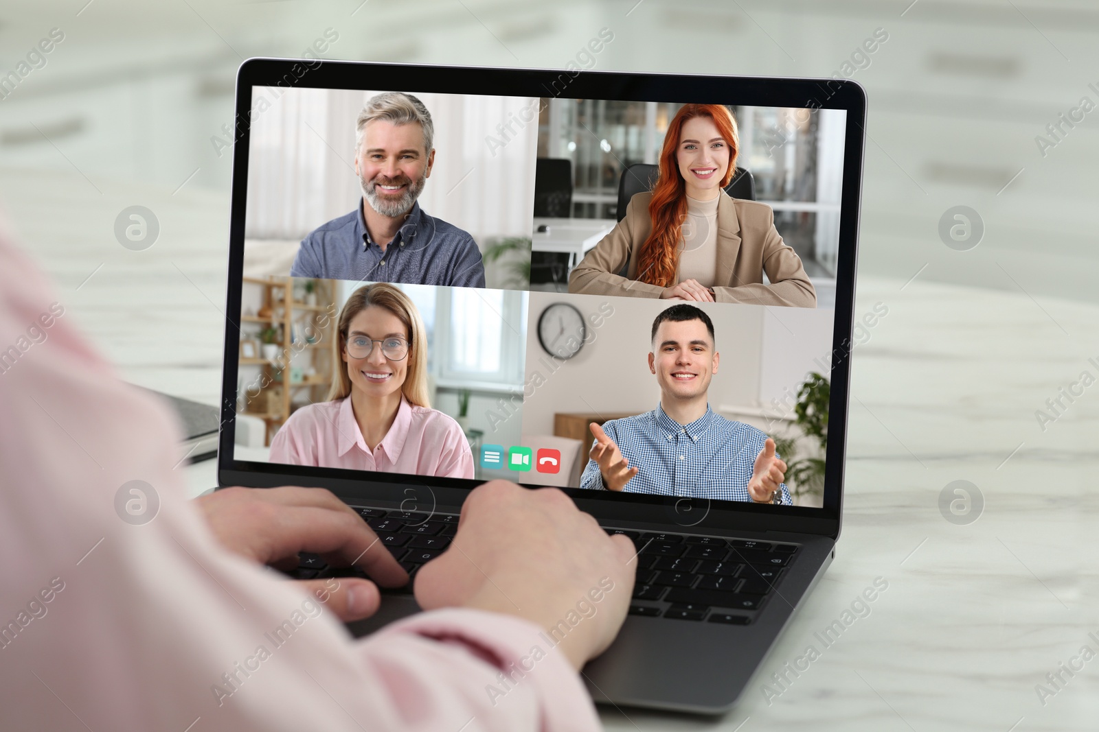 Image of Woman having video chat with coworkers via laptop at white table, closeup