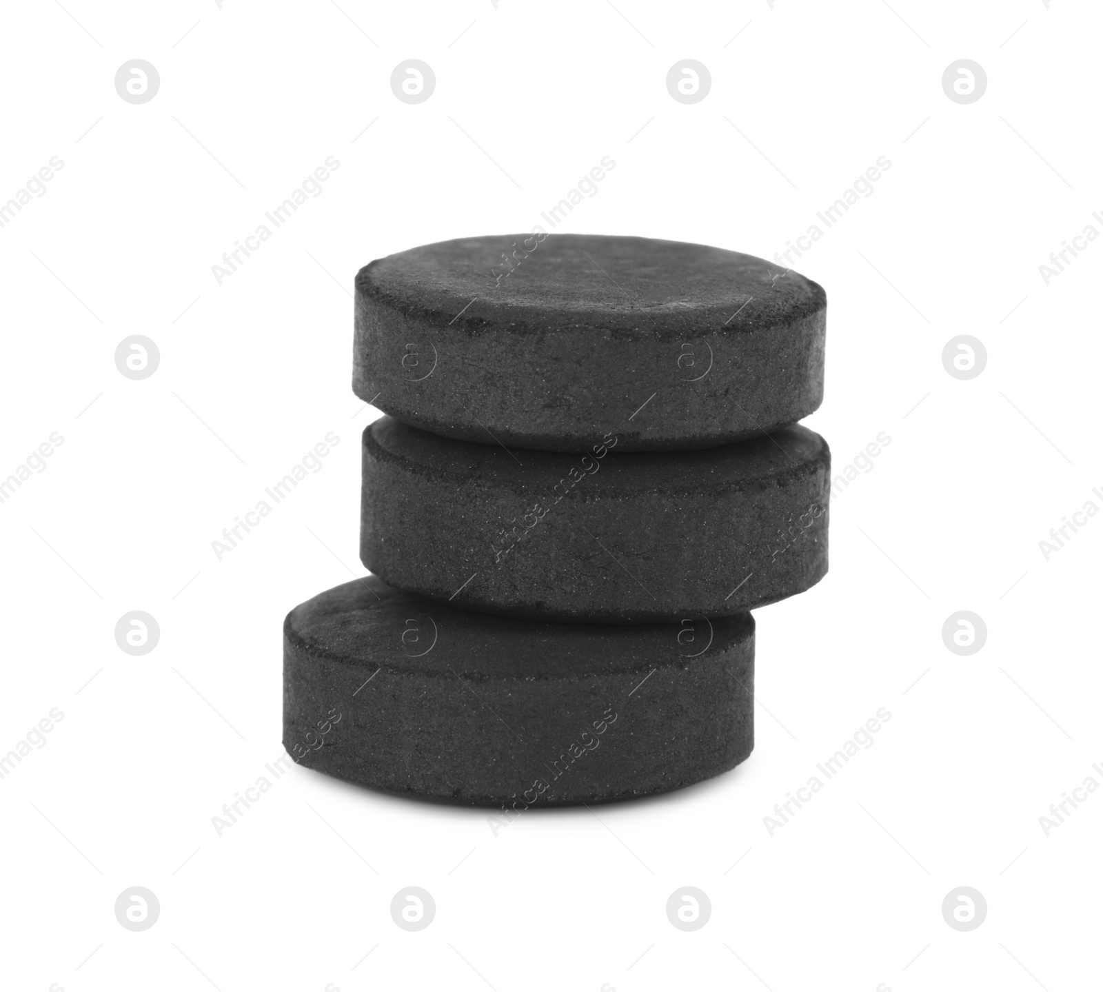 Photo of Activated charcoal pills on white background. Potent sorbent