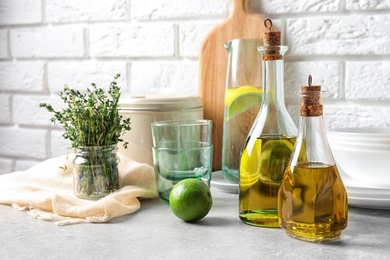 Fresh olive oil and kitchen utensils on table