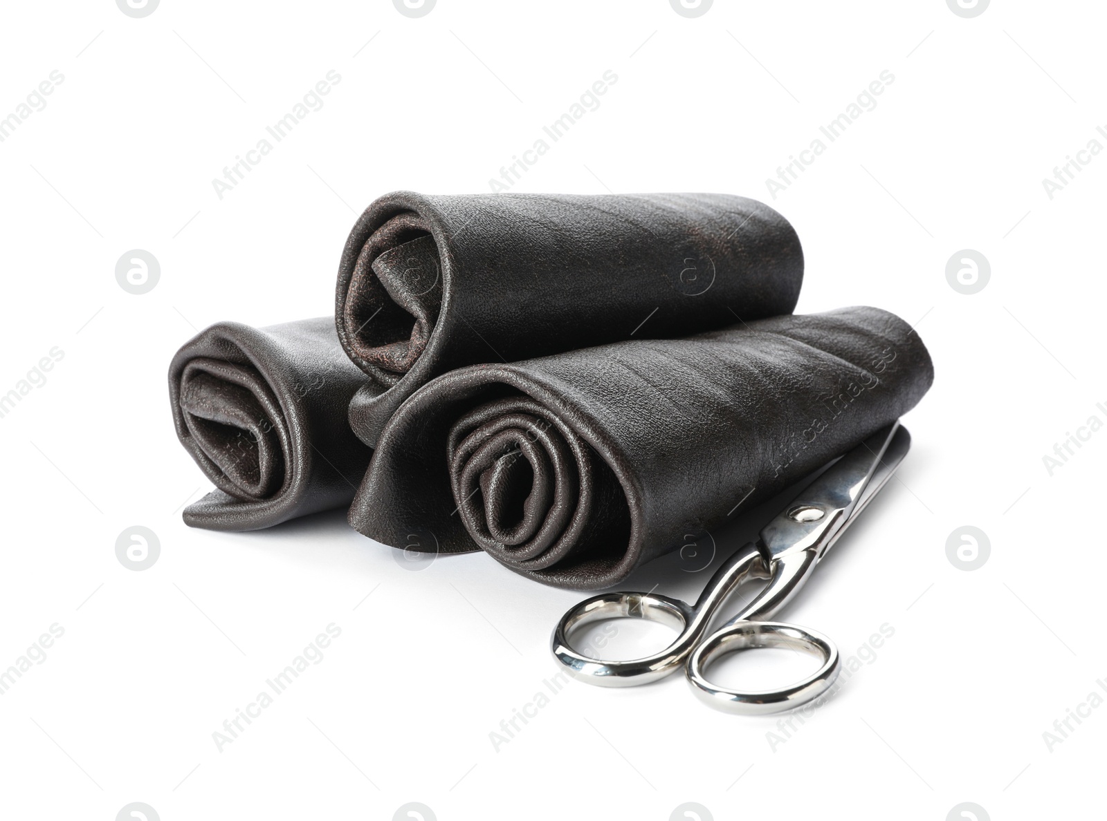 Photo of Black leather samples and craftsman scissors isolated on white