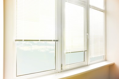 Image of Stylish window with horizontal blinds in room