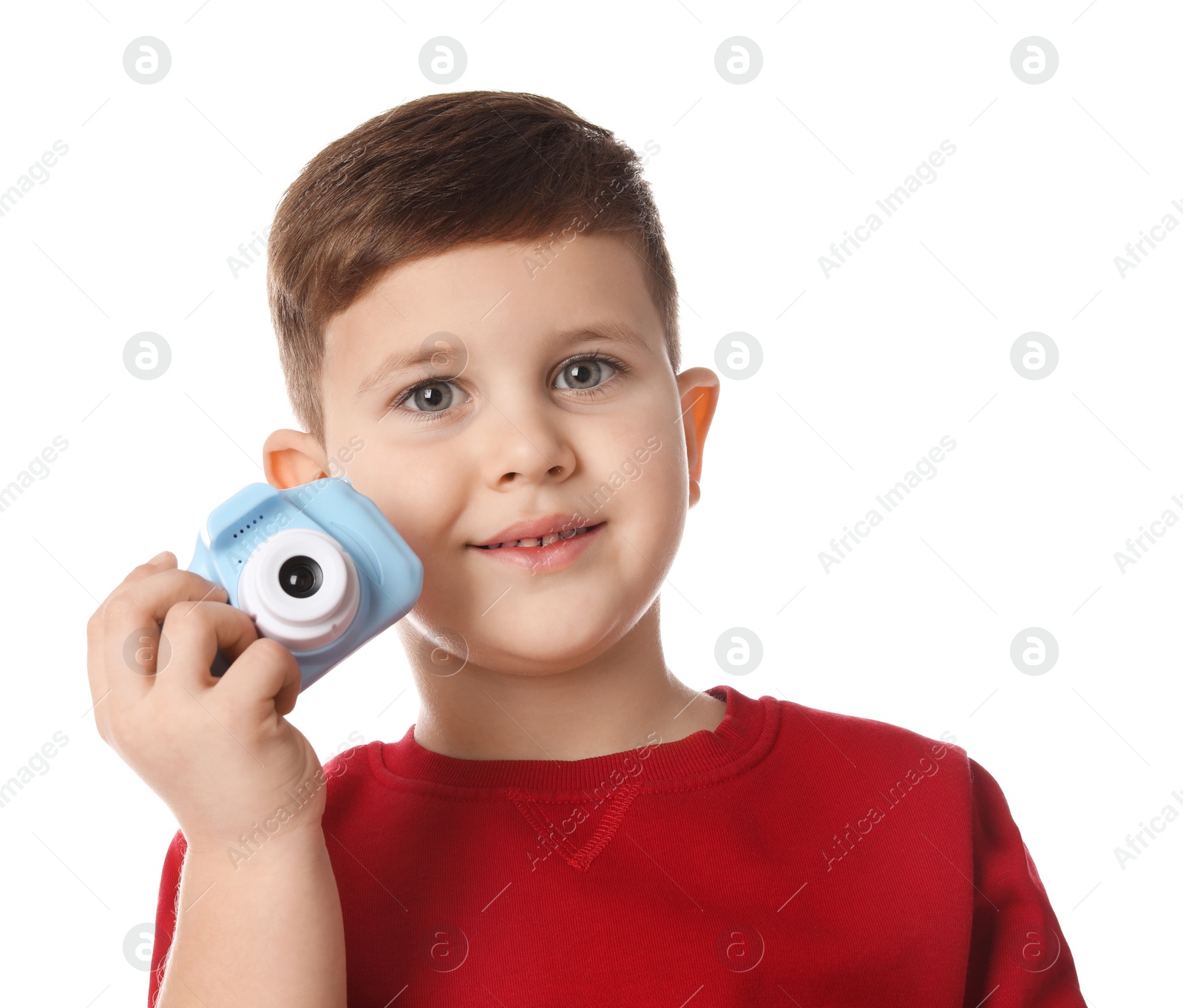 Photo of Little photographer with toy camera on white background