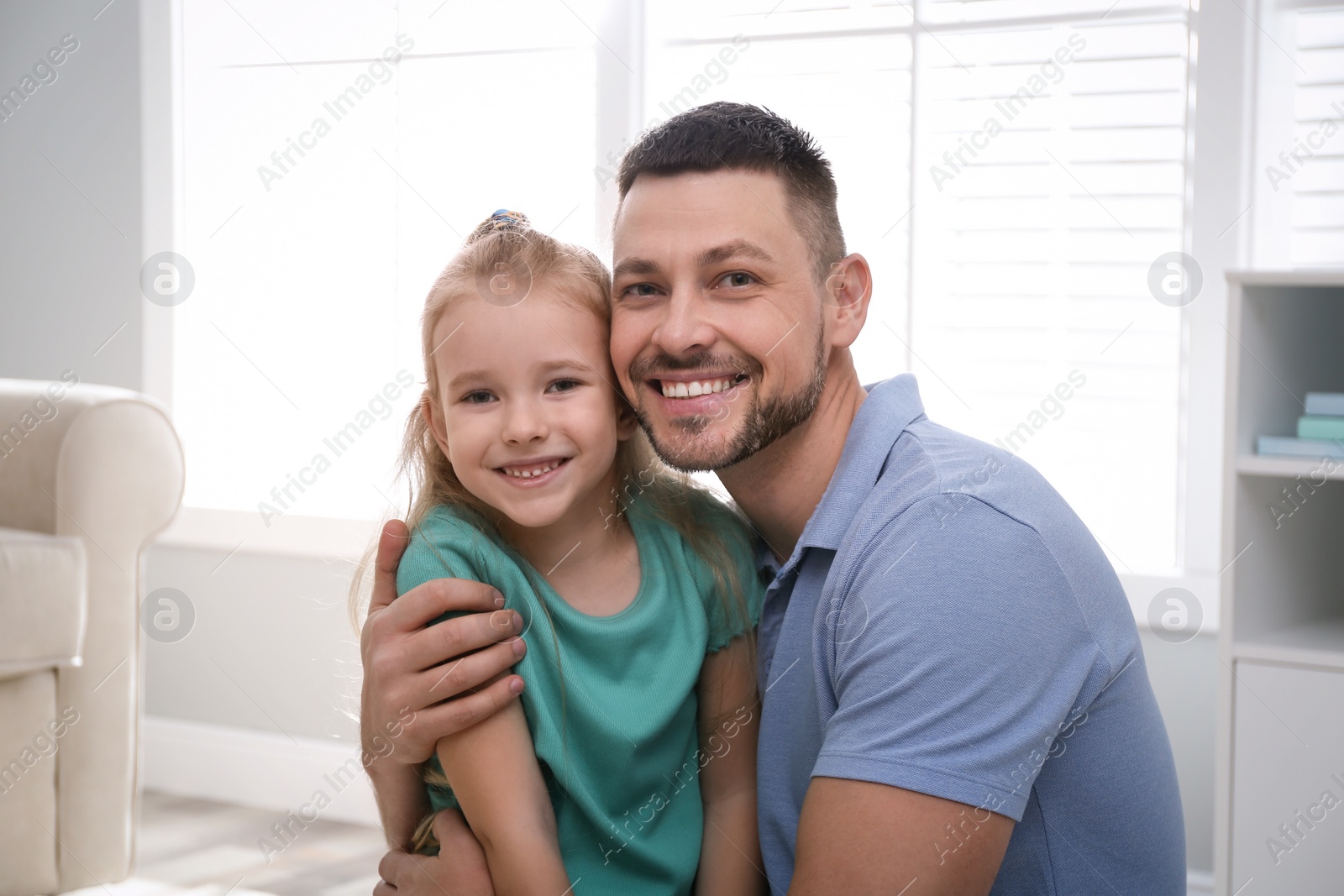 Photo of Dad and daughter spending time together at home. Happy Father's Day