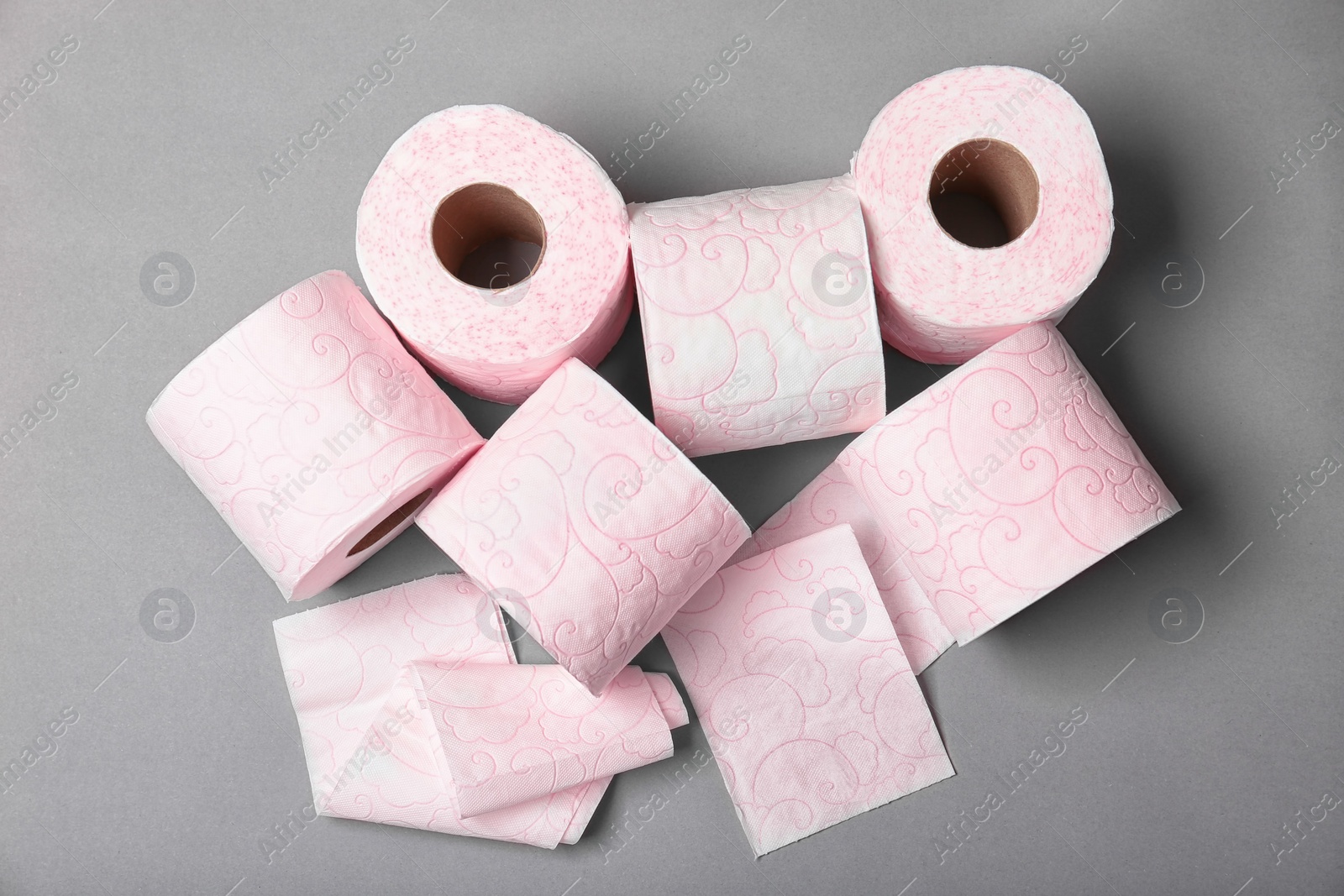 Photo of Rolls of toilet paper on grey background, top view. Personal hygiene