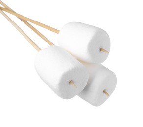 Photo of Sticks with delicious puffy marshmallows on white background