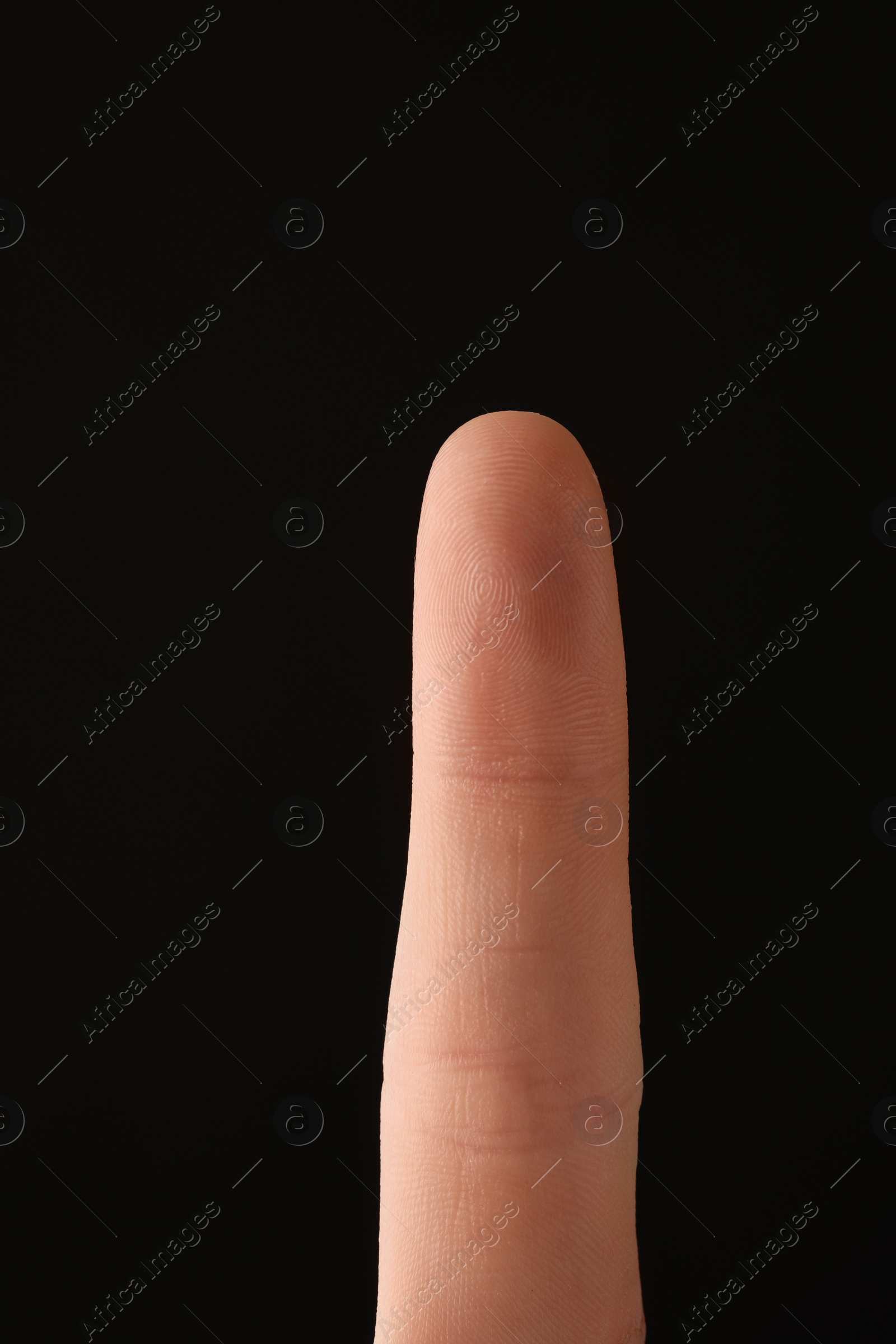 Photo of Man scanning fingerprint on black background, closeup