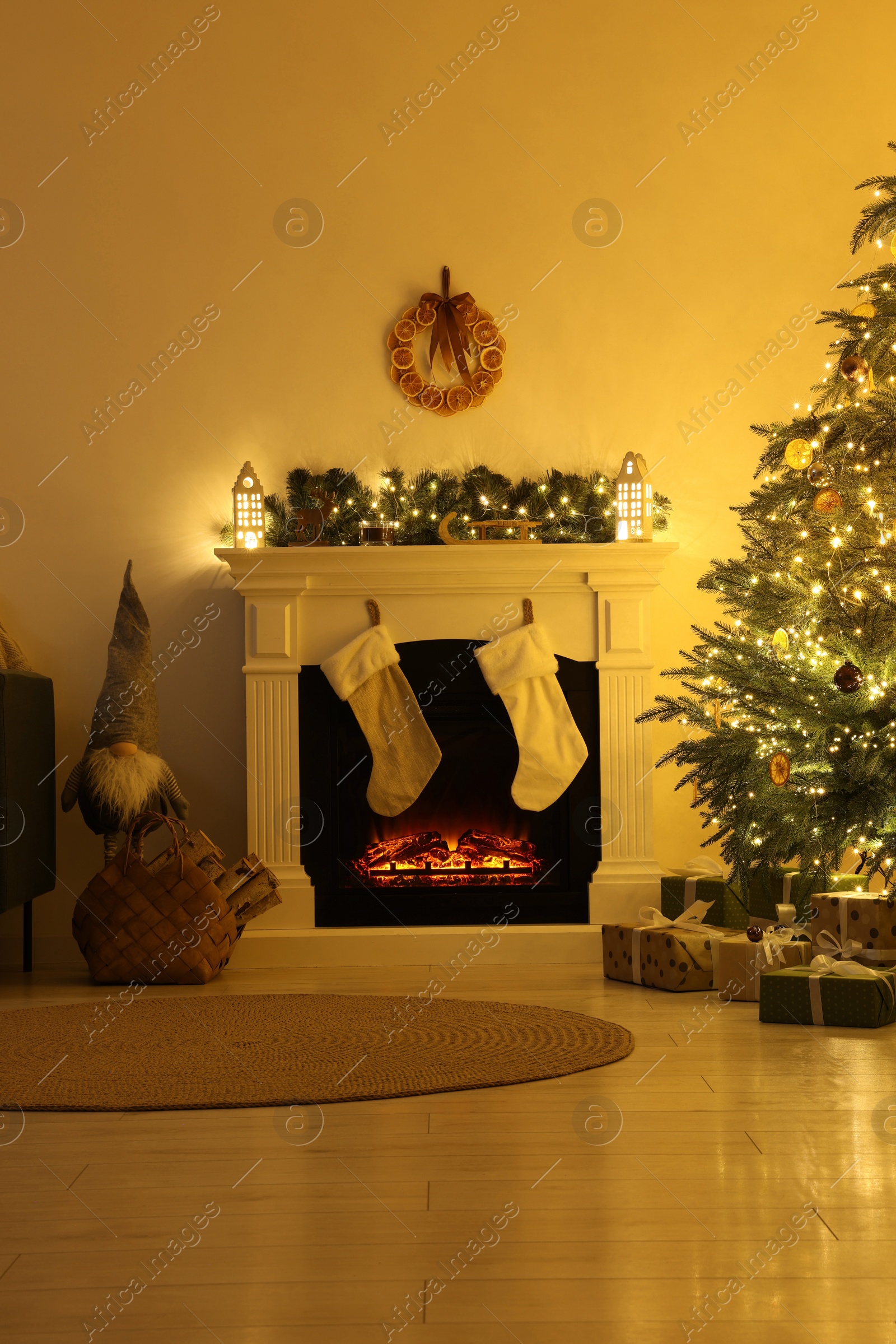 Photo of Stylish fireplace with Christmas decorations in cosy room