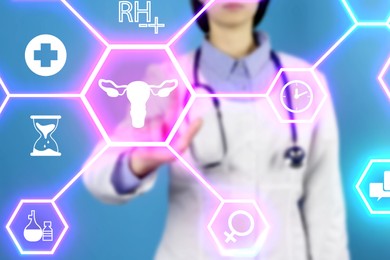 Menopause concept. Doctor touching uterus icon on digital screen against blue background, closeup