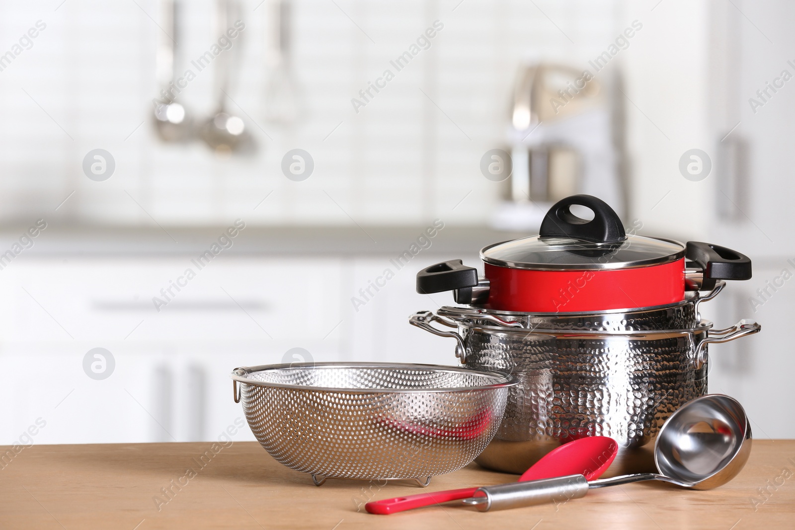 Photo of Set of clean cookware and utensils on table in kitchen. Space for text