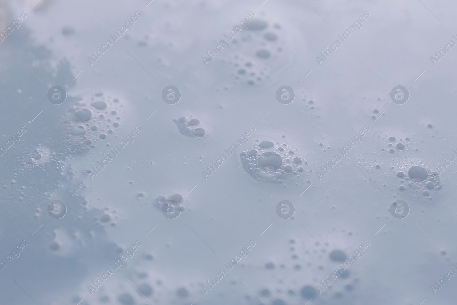 Photo of Texture of white shower gel as background, closeup