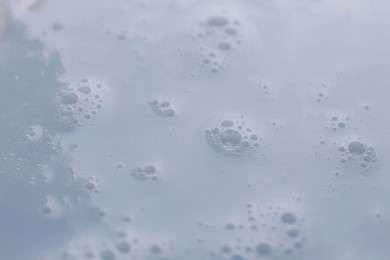 Photo of Texture of white shower gel as background, closeup