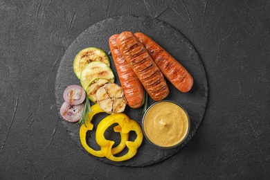 Photo of Flat lay composition with delicious grilled sausages on black table. Barbecue food