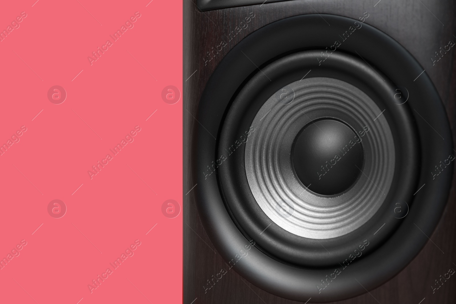 Photo of One wooden sound speaker on red background, closeup. Space for text