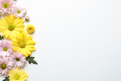 Photo of Beautiful chamomile flowers on white background, flat lay with space for text