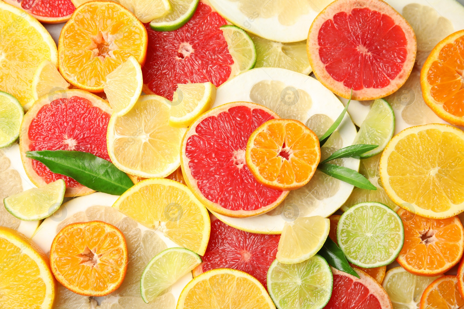 Photo of Different citrus fruits as background, top view