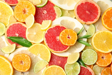 Photo of Different citrus fruits as background, top view