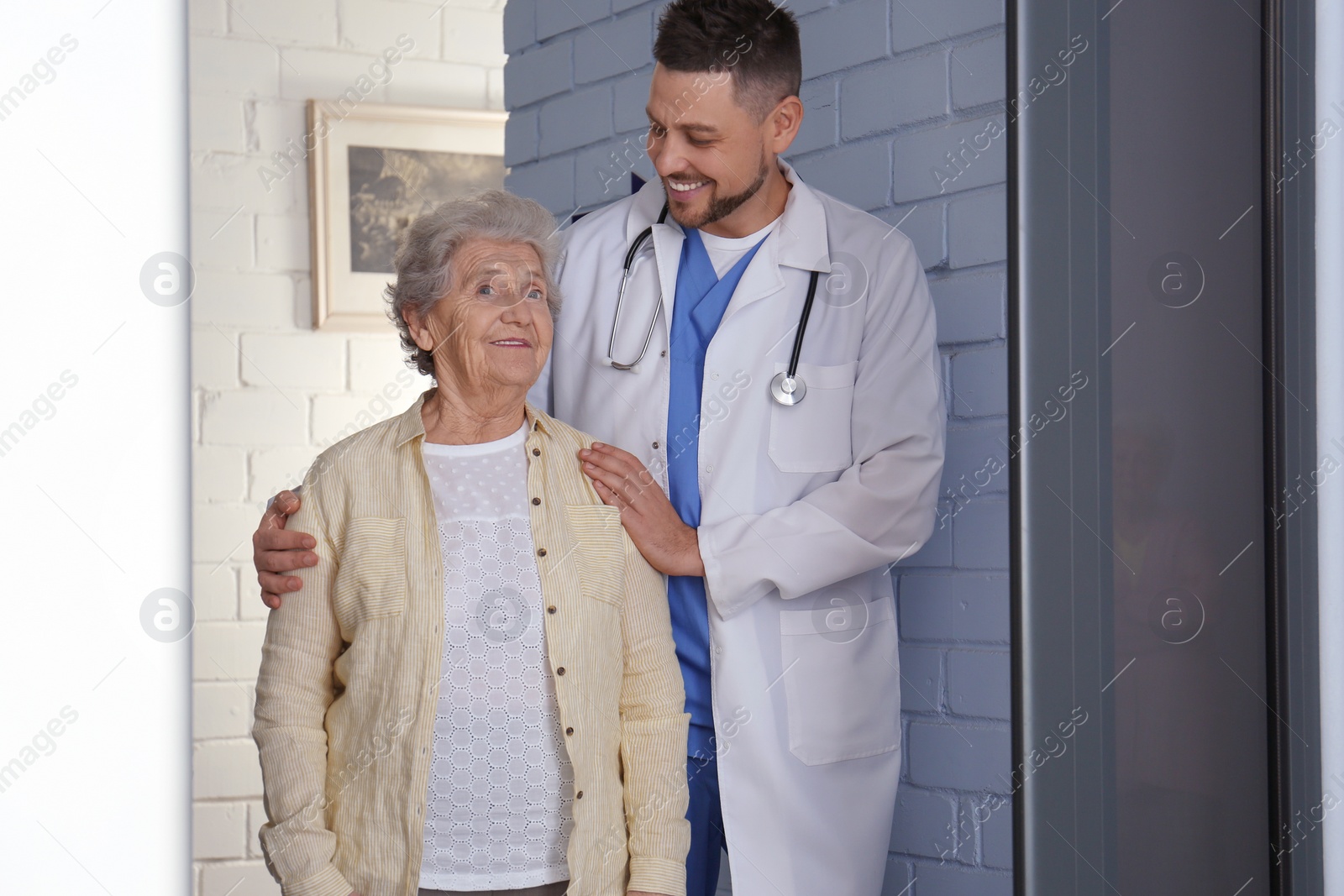 Photo of Doctor with senior patient at modern hospital