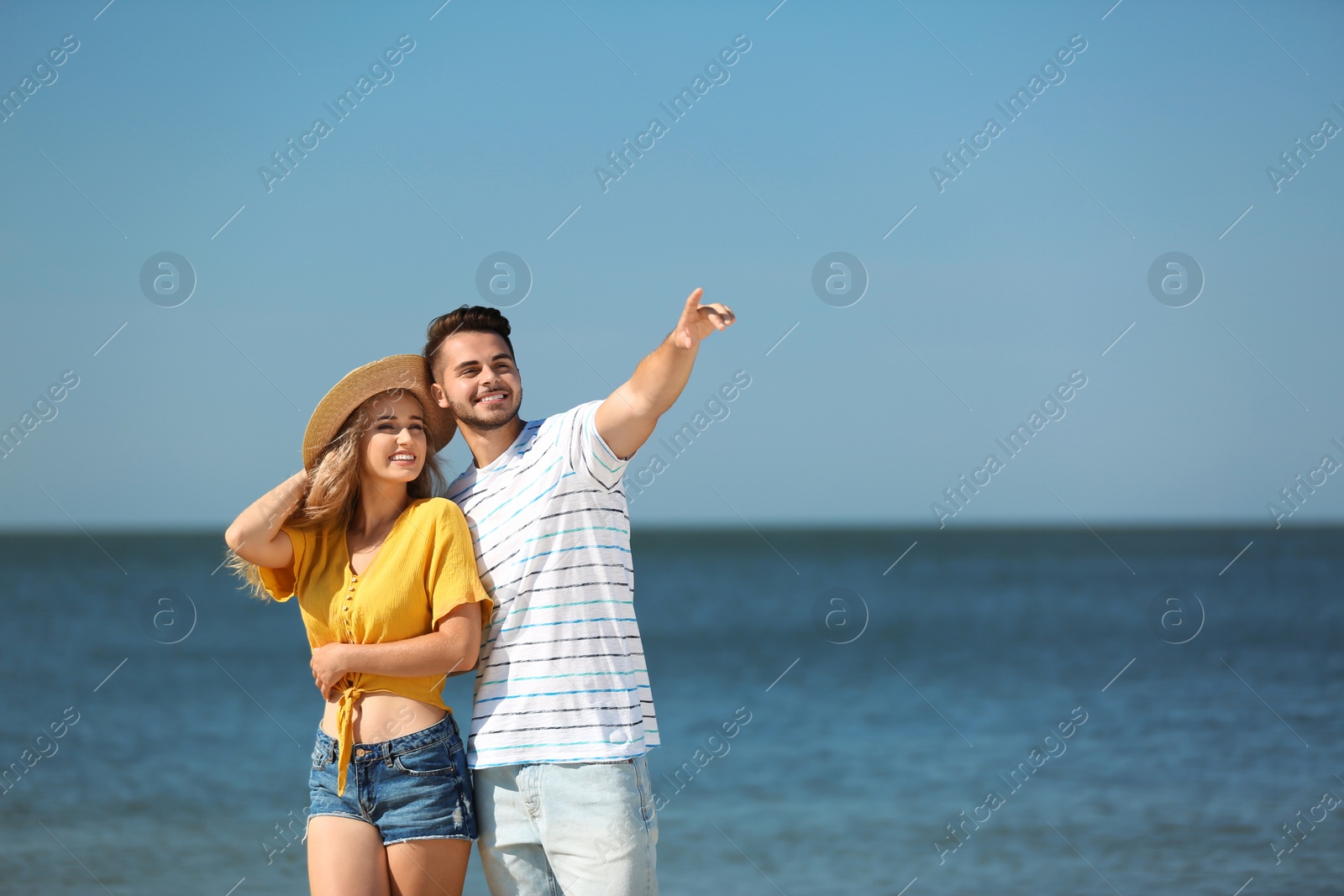 Photo of Happy young couple at beach on sunny day