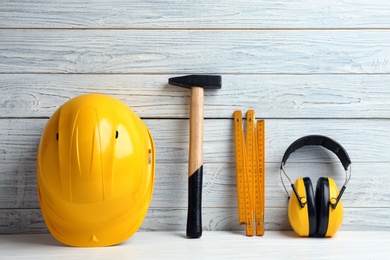 Photo of Composition with construction tools on table against wooden background