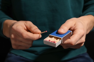 Man with box of matches, closeup of hands