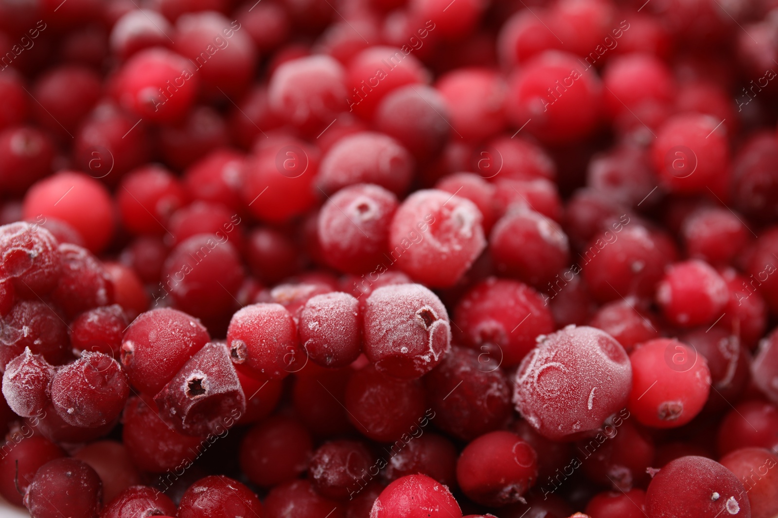 Photo of Frozen red cranberries as background, closeup view