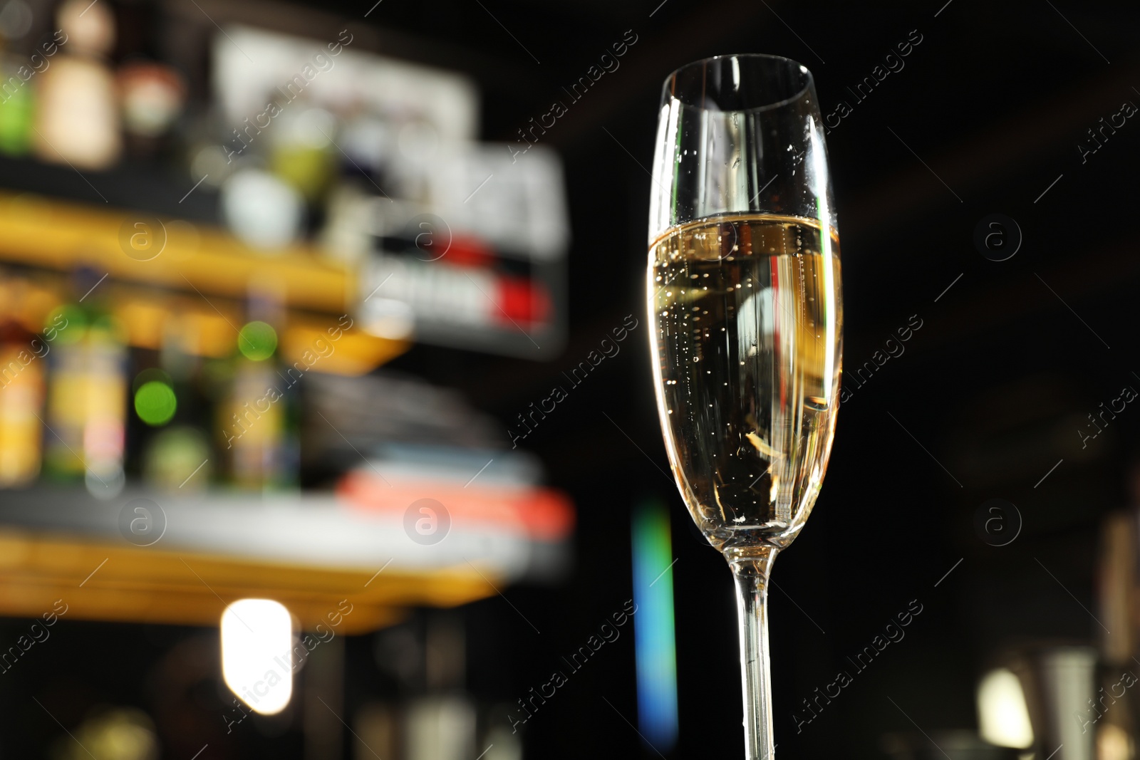 Photo of Glass of champagne in bar, low angle view. Space for text
